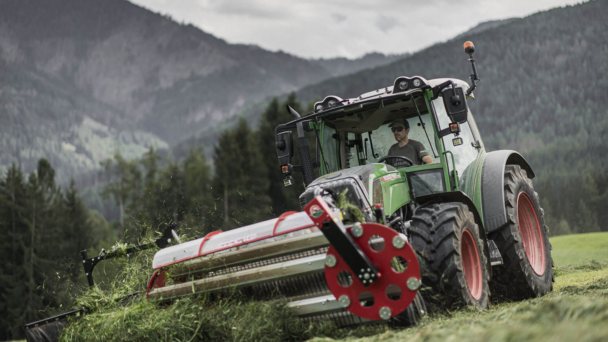 Farmer in the tractor mowing - Obermairhof in Valdaora