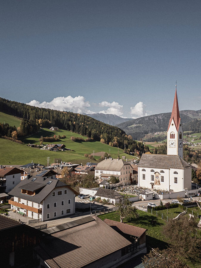 Obermairhof and Valdaora di Sotto from above - vertical format - Obermairhof in Valdaora